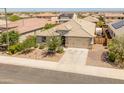 An aerial view showcases a single-story home with desert landscaping and a private backyard at 26032 W Quail Ave, Buckeye, AZ 85396