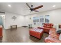 Inviting living room showcasing a brick-toned leather sectional sofa, ceiling fan, and tiled flooring at 2731 N 23Rd Ave, Phoenix, AZ 85009
