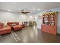 Open-concept living room featuring a red leather sectional sofa and tiled flooring at 2731 N 23Rd Ave, Phoenix, AZ 85009