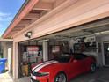 Spacious garage featuring a red sports car and patriotic decor at 2840 W Marlette Ave, Phoenix, AZ 85017