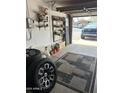 Garage interior with organized tools, tires, and blue pickup truck partially visible at 2840 W Marlette Ave, Phoenix, AZ 85017