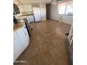 Kitchen with tile floor and white appliances at 3104 E Broadway Rd # 295, Mesa, AZ 85204