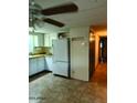Functional kitchen features tile flooring, white cabinets, and modern refrigerator at 3104 E Broadway Rd # 295, Mesa, AZ 85204