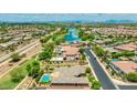 Expansive aerial view showcasing the community, including a lake, green spaces, and surrounding homes at 3400 S Whetstone Pl, Chandler, AZ 85286