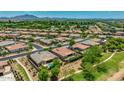 A wide aerial view highlights the neighborhood with well-maintained homes, green spaces, and serene surroundings at 3400 S Whetstone Pl, Chandler, AZ 85286