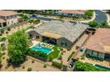 An aerial shot highlights a spacious backyard with a pool, patio area, and lush landscaping at 3400 S Whetstone Pl, Chandler, AZ 85286