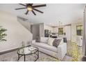 Comfortable living room showcasing a stylish sofa, a modern fan, and an open floor plan at 3900 E Baseline Rd # 137, Phoenix, AZ 85042