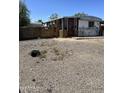 Cozy single-story home featuring a red door, small porch, and an expansive gravel front yard at 4233 E Minton St, Phoenix, AZ 85042