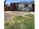 Charming single-story home with a red door and small porch, complemented by a spacious front yard at 4233 E Minton St, Phoenix, AZ 85042