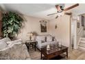 Cozy living room featuring comfortable seating, a ceiling fan, and neutral decor at 4434 E Wood St, Phoenix, AZ 85040
