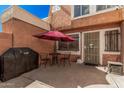 Inviting patio area with a table, chairs, and grill, perfect for outdoor dining at 4434 E Wood St, Phoenix, AZ 85040