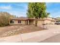 Charming single-story home with a two-car garage and mature landscaping at 4510 W North Ln, Glendale, AZ 85302