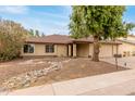 Charming single-story home with a two-car garage and mature landscaping at 4510 W North Ln, Glendale, AZ 85302