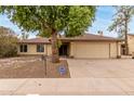 Charming single-story home with a two-car garage and mature landscaping at 4510 W North Ln, Glendale, AZ 85302