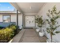 Inviting front porch with double doors, potted plants, and a well-maintained garden at 4645 E Covina St, Mesa, AZ 85205