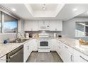 Bright kitchen featuring white cabinets, stainless steel appliances, and light granite countertops at 4645 E Covina St, Mesa, AZ 85205