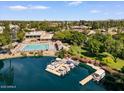 Scenic aerial view of lake community featuring a beautiful pool, lush landscaping, and boat slips at 5200 S Lakeshore Dr # 120, Tempe, AZ 85283
