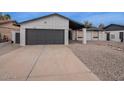 Inviting home showcasing a garage, desert landscaping, and a well-maintained front yard at 5817 S Siesta Ln, Tempe, AZ 85283