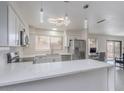 Bright kitchen boasts modern stainless steel appliances, sleek countertops, and a breakfast bar at 5817 S Siesta Ln, Tempe, AZ 85283