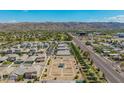 Expansive aerial view of the neighborhood featuring a community garden, scenic mountain views, and desert landscaping at 6550 S 24Th Pl, Phoenix, AZ 85042