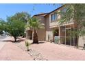 Charming two-story condo featuring well-maintained landscaping, including a small palm tree at 7120 E Wilshire Dr # 10, Scottsdale, AZ 85257