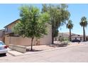 Corner view of a residential building with mature trees and minimal desert landscaping at 7120 E Wilshire Dr # 10, Scottsdale, AZ 85257