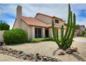 Charming home with desert landscaping, a tile roof, and a beautiful accent cactus at 7625 W Dreyfus Dr, Peoria, AZ 85381