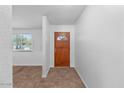 Bright entryway featuring tile floors, fresh paint, and a wooden front door at 842 E Village Circle N Dr, Phoenix, AZ 85022