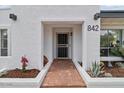 Inviting front entry with a brick walkway, desert landscaping, and a white exterior at 842 E Village Circle N Dr, Phoenix, AZ 85022