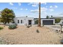 Inviting single-story home featuring desert landscaping, a two-car garage, and a freshly painted white exterior at 842 E Village Circle N Dr, Phoenix, AZ 85022