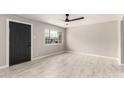 Inviting living room with tile flooring, large window, and dark entry door at 1010 W 5Th Pl, Mesa, AZ 85201