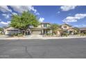 Inviting two-story home featuring a well-maintained lawn, desert landscaping, and a convenient two-car garage at 11629 W Washington St, Avondale, AZ 85323