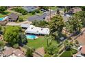 Aerial view of the home with lush backyard, swimming pool, mature shade trees, and a covered carport at 1298 E Buffalo St, Chandler, AZ 85225
