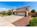 Lovely two-story home boasting a three-car garage, complemented by desert-style landscaping at 13005 W Vista Paseo Dr, Litchfield Park, AZ 85340