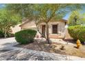 Quaint single-story home with desert landscaping, a two-car garage, and a tile roof at 1314 S Bridgegate Dr, Gilbert, AZ 85296