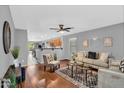 Bright living room with hardwood floors, comfortable seating, and an open floor plan at 1314 S Bridgegate Dr, Gilbert, AZ 85296