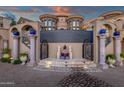 An inviting estate entrance with columns and a decorative tile design leading to the main house at 15536 E Heavenly Vista Trl, Fountain Hills, AZ 85268