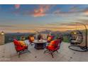 Outdoor patio seating area with comfortable chairs, a fire pit, and picturesque mountain views at 15536 E Heavenly Vista Trl, Fountain Hills, AZ 85268