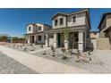 New construction home showcasing a charming two-story facade with a welcoming front porch at 15593 S 180Th Ln, Goodyear, AZ 85338