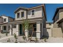 Inviting two-story home featuring a charming facade and desert landscaping in the front yard at 15593 S 180Th Ln, Goodyear, AZ 85338