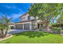 Well-manicured lawn and mature trees add curb appeal to this home at 1697 E Linda Ln, Gilbert, AZ 85234