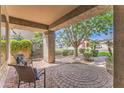 Charming covered patio with brick flooring and comfortable seating area at 1697 E Linda Ln, Gilbert, AZ 85234