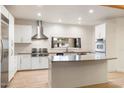 Modern kitchen featuring stainless steel appliances, a subway tile backsplash, and a center island at 1801 E Berridge Ln, Phoenix, AZ 85016