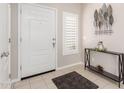 Inviting foyer with neutral tones, a console table, and a decorative leaf sculpture at 19847 W Monroe St, Buckeye, AZ 85326