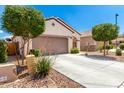Single-story home with a 2-car garage, desert landscaping, and a paved driveway at 19847 W Monroe St, Buckeye, AZ 85326