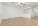 Bright living room featuring neutral walls, a ceiling fan, and tile flooring at 2046 E Paradise Ln, Phoenix, AZ 85022
