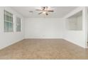 Spacious living room with tile floors, a ceiling fan, and plenty of natural light at 2046 E Paradise Ln, Phoenix, AZ 85022