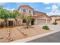 Attractive two-story home featuring a three-car garage and desert landscaping at 2286 E Mohave Ln, Apache Junction, AZ 85119