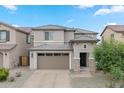 Charming two-story home with a two-car garage and desert landscaping, perfect for curb appeal at 23010 E Pummelos Rd, Queen Creek, AZ 85142