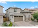 Charming two-story home with a two-car garage and desert landscaping, perfect for curb appeal at 23010 E Pummelos Rd, Queen Creek, AZ 85142
